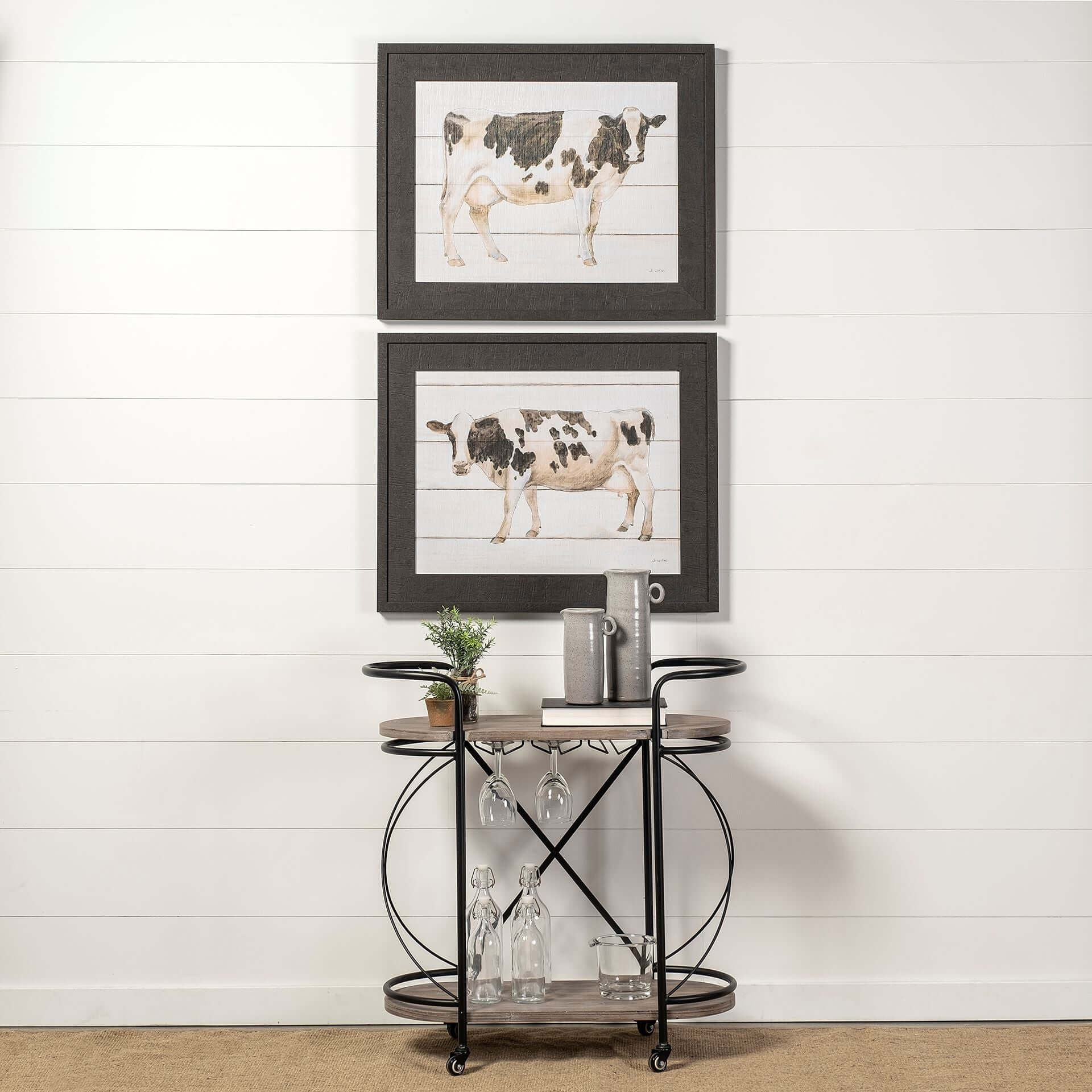 Black Solid Wood and Steel Rolling Kitchen Cart With Storage featuring artistic cow prints above.