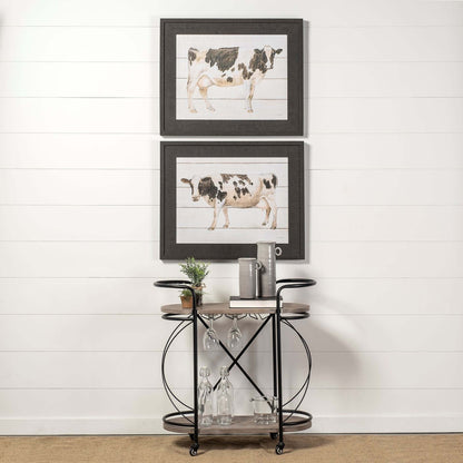 Black Solid Wood and Steel Rolling Kitchen Cart With Storage featuring artistic cow prints above.