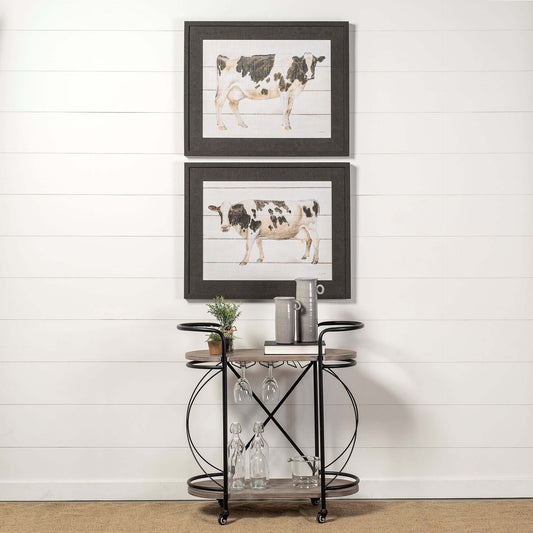 Black Solid Wood and Steel Rolling Kitchen Cart With Storage featuring artistic cow prints above.
