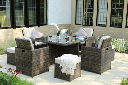 HOMEROOTS Nine Piece Clear and Gray Glass Dining Set featuring modern design and elegant glass top in outdoor setting.