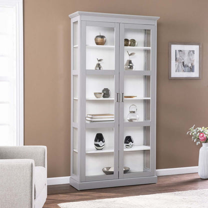 Gray double door curio cabinet showcasing decorative items in a stylish home setting with cornice molding.