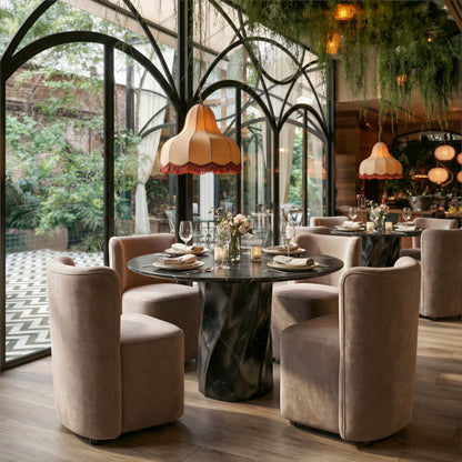Homeroots Black Marble and Wood Round Top Dining Table set in an elegant dining space with stylish chairs and decorative lighting.